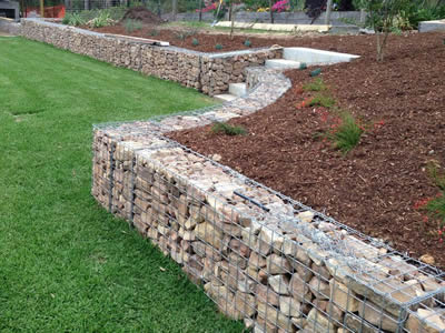 Welded gabions are installed on the grassland with soils on the slope.