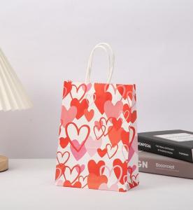 China Red 80gsm Kraft Paper Gift Bags Love Heart Printed Paper Goodie Bags With Handles wholesale