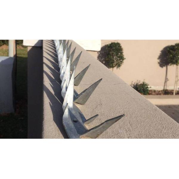Wall spikes are installed at the top of wall.